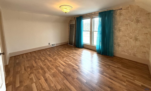 empty room featuring wood-type flooring