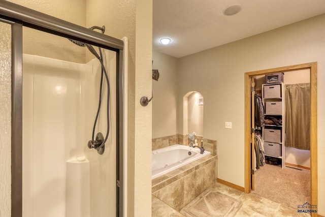 bathroom featuring tile patterned flooring and plus walk in shower