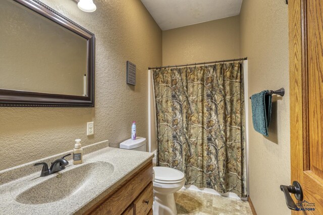 bathroom with vanity, toilet, and a shower with shower curtain