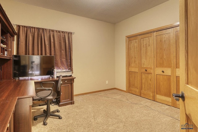 office with light carpet and a textured ceiling