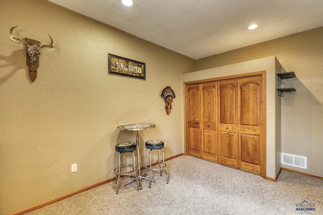 interior space featuring light carpet