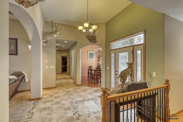 entrance foyer with an inviting chandelier and a towering ceiling