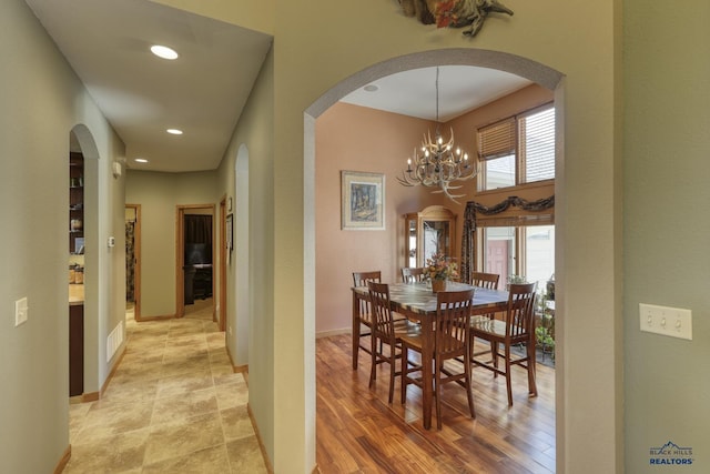 dining area with a chandelier and light hardwood / wood-style floors