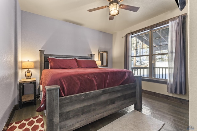 bedroom featuring dark wood-type flooring and ceiling fan