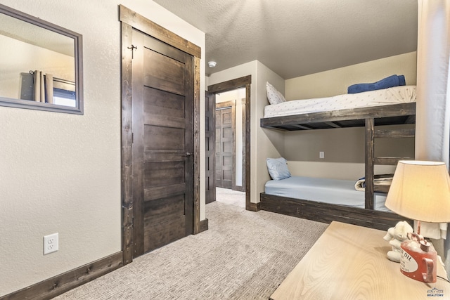 bedroom featuring carpet floors and a textured ceiling