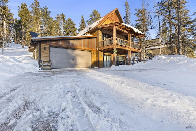 view of front of home with a garage and a deck