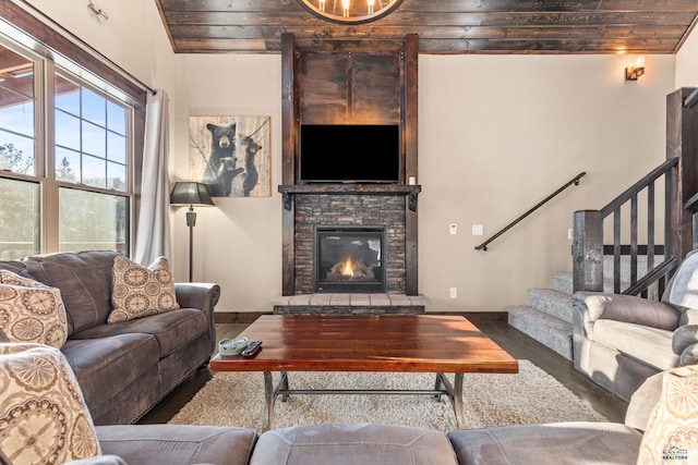 living room featuring wooden ceiling, a fireplace, stairway, and wood finished floors