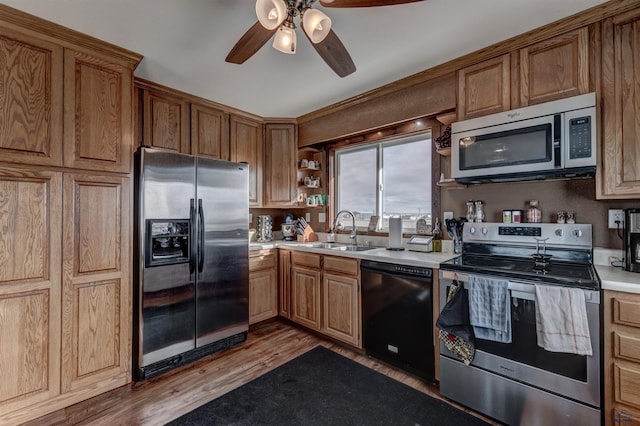 kitchen with hardwood / wood-style flooring, ceiling fan, stainless steel appliances, and sink