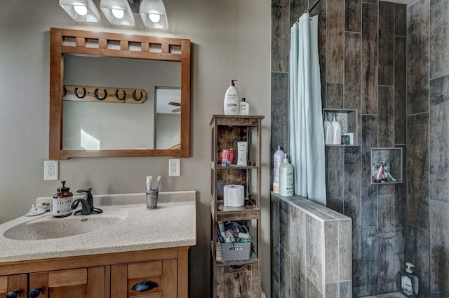 bathroom featuring vanity and a shower with shower curtain