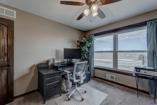 office space featuring ceiling fan and light carpet