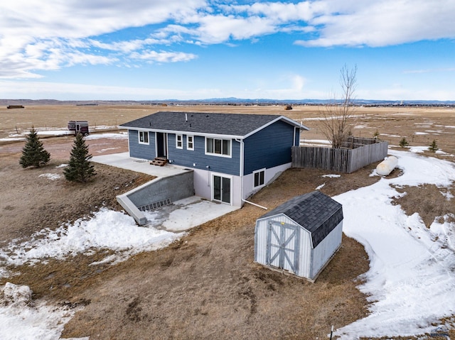 snowy aerial view featuring a rural view