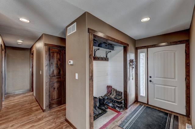 entryway featuring a textured ceiling and light wood-type flooring