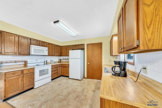 kitchen with tasteful backsplash and white appliances