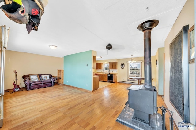 living room with light wood-type flooring and a wood stove