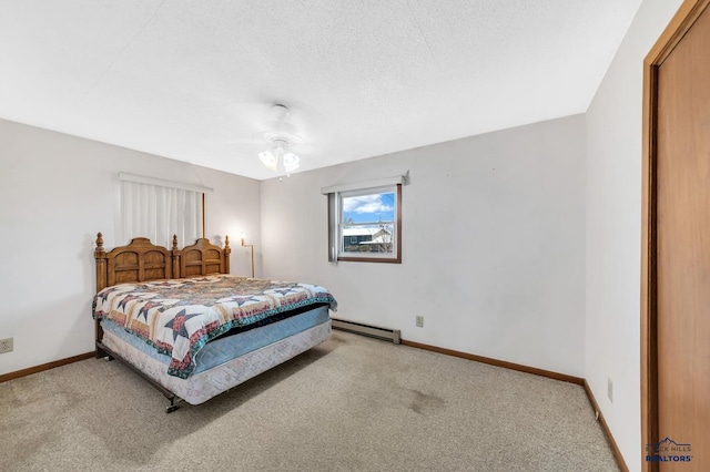 bedroom with a baseboard radiator, light colored carpet, and a textured ceiling