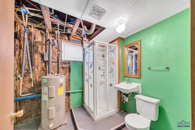 bathroom featuring toilet, a shower with shower door, sink, concrete floors, and electric water heater