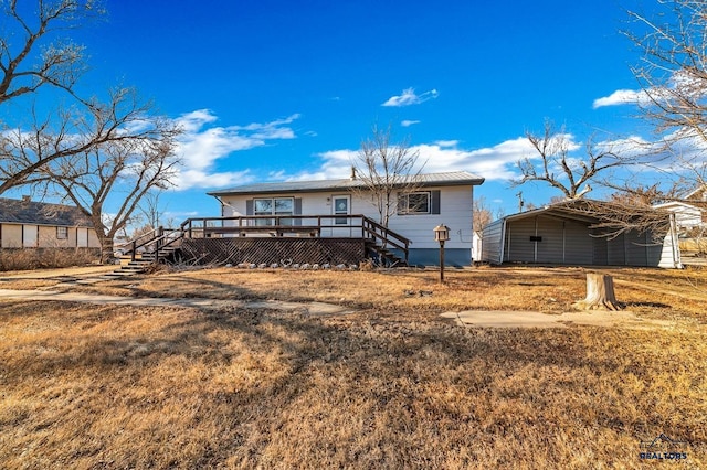 view of front of property featuring a wooden deck, a front lawn, and a carport