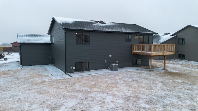 back of house featuring central AC and a deck