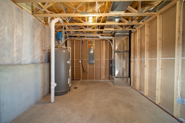 basement featuring water heater and electric panel