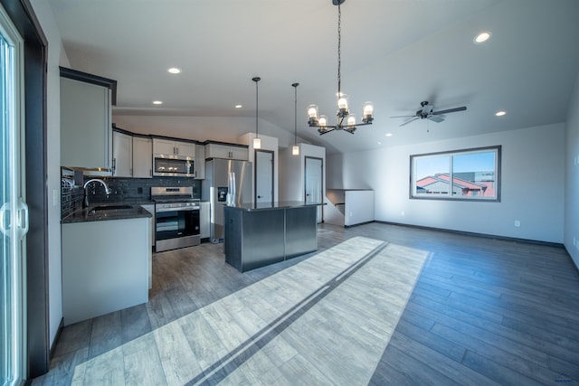 kitchen with sink, gray cabinets, hanging light fixtures, stainless steel appliances, and a center island