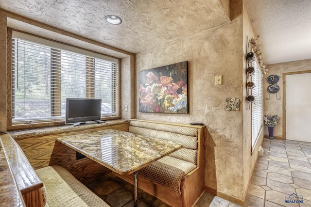 sitting room featuring a textured ceiling and breakfast area