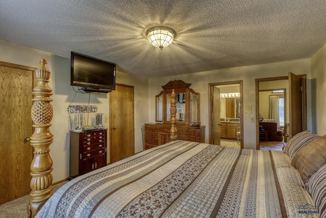 bedroom with a textured ceiling and ensuite bathroom