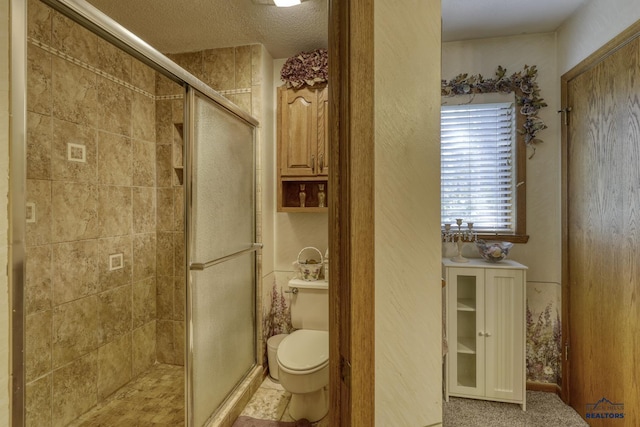 bathroom with toilet and a shower with door