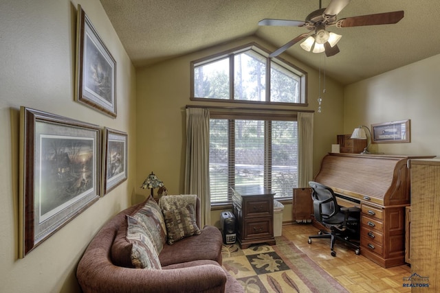 office space with light parquet floors, ceiling fan, lofted ceiling, and a textured ceiling