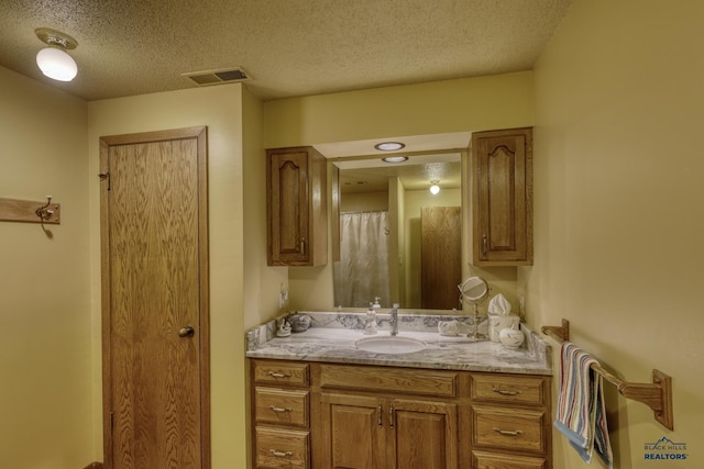 bathroom featuring vanity and a textured ceiling