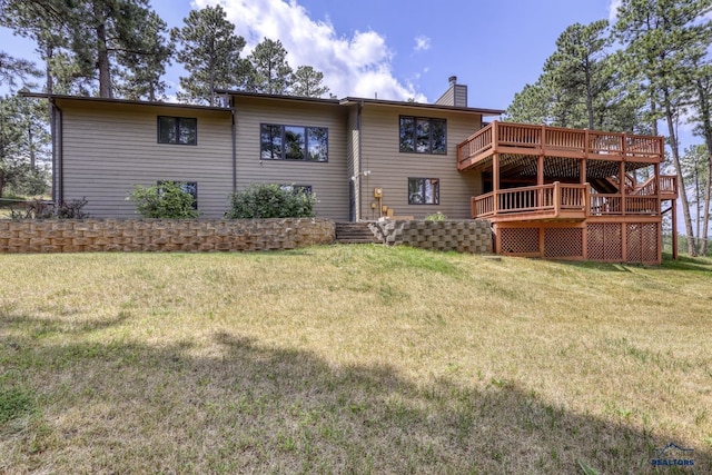 rear view of property with a deck and a lawn