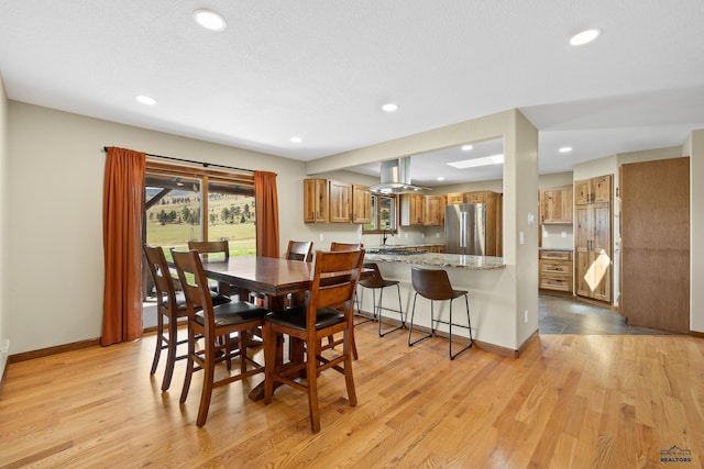 dining space featuring sink and light hardwood / wood-style floors