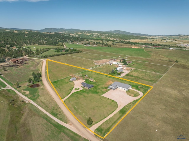 drone / aerial view with a mountain view and a rural view