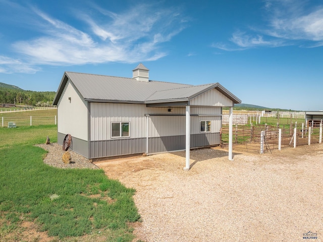 exterior space with an outbuilding and a rural view