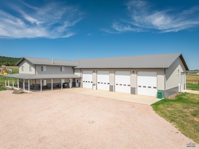 view of front of property featuring a carport and a garage