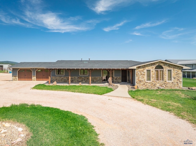 ranch-style home with a garage and a front yard