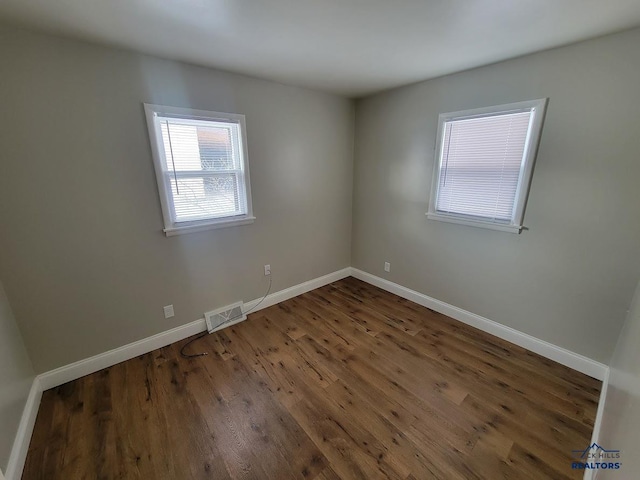 unfurnished room featuring dark hardwood / wood-style floors