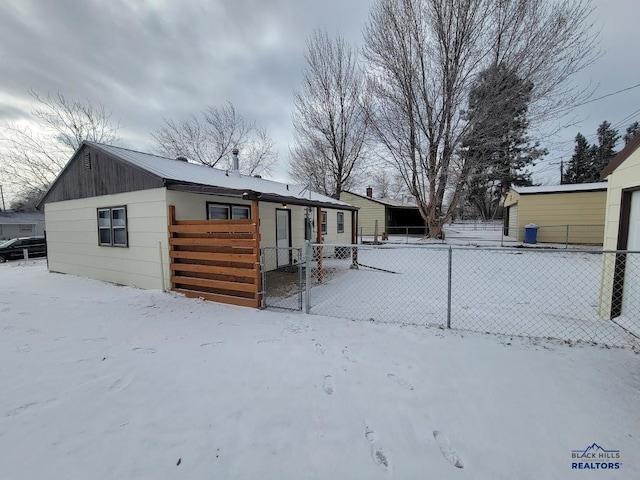 view of snow covered rear of property