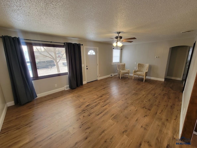 foyer entrance featuring hardwood / wood-style flooring, a textured ceiling, and ceiling fan