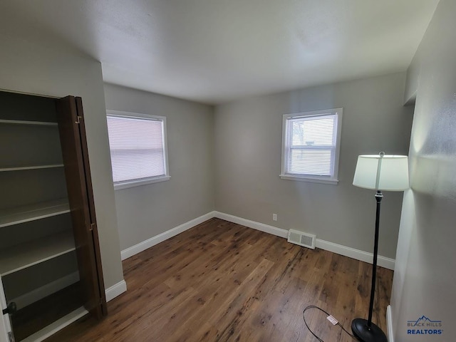 spare room featuring dark wood-type flooring