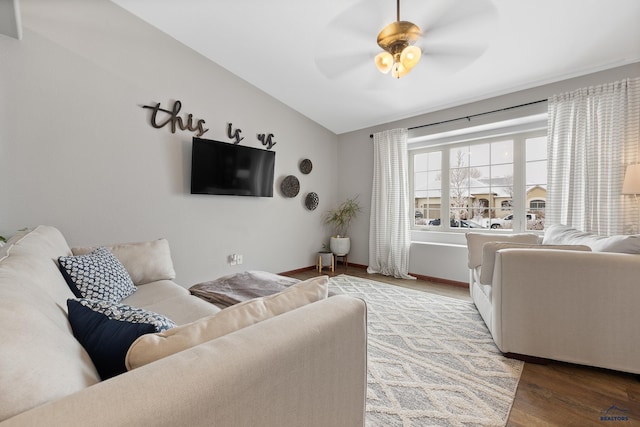 living room featuring vaulted ceiling, ceiling fan, and light wood-type flooring