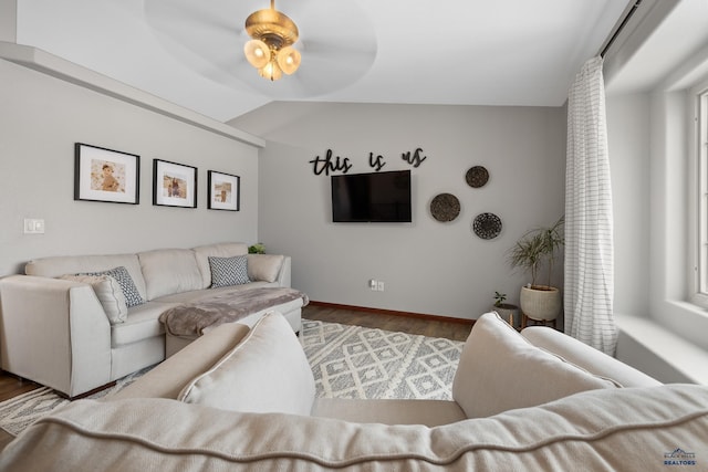 living room with hardwood / wood-style flooring, lofted ceiling, and ceiling fan