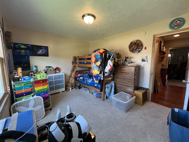 carpeted bedroom featuring a textured ceiling