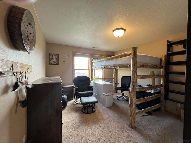 carpeted bedroom featuring a textured ceiling