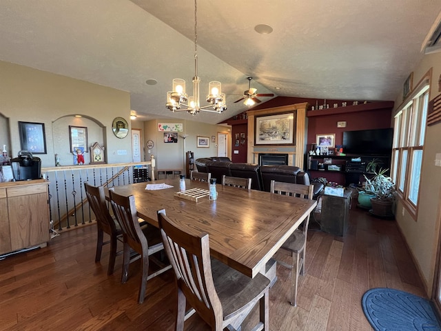 dining area featuring lofted ceiling, dark hardwood / wood-style flooring, and a chandelier