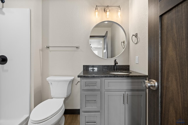 bathroom featuring hardwood / wood-style flooring, vanity, and toilet