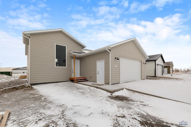 view of snow covered exterior featuring a garage