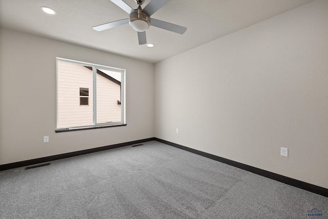 carpeted empty room featuring ceiling fan