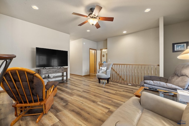 living room featuring light hardwood / wood-style floors and ceiling fan