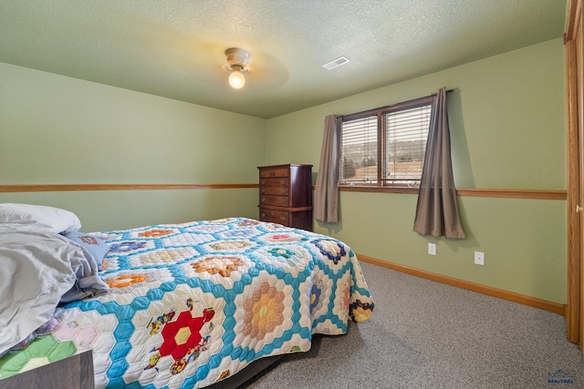 carpeted bedroom with ceiling fan and a textured ceiling