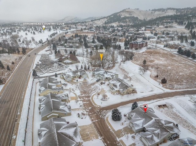 snowy aerial view featuring a mountain view